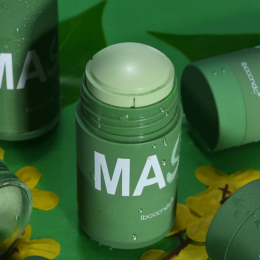 Green cleansing stick mask in a sleek green container, product on a green background with water droplets, easy-to-apply skin care mask