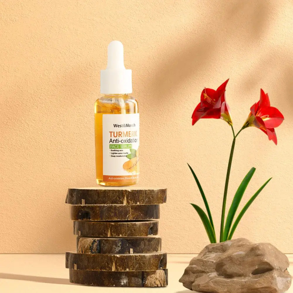 Turmeric Dark Spot Corrector Face Care serum in a small glass bottle with white dropper, on stacked wooden coasters against beige wall