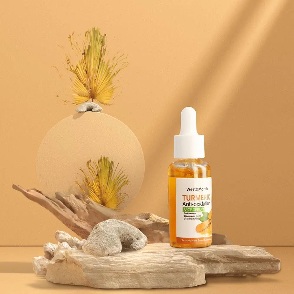 West&Month Turmeric Dark Spot Corrector Face Care serum in small amber glass bottle with white dropper, on natural stone display with dried plants, beige background